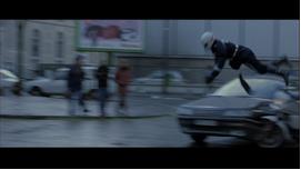 Finally, we see the action of a motorcyclist crashing into a civilian vehicle, broken into three separate edits. By fragmenting the single event, the collision gains a quality of dissonance. This tendency of jarring discord seeks to startle the viewer, illustrating the films preference for emotional response over a unity of the progression of events.